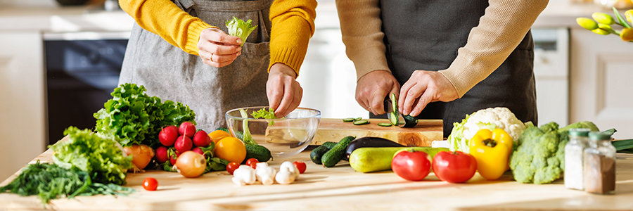 Two people preparing food in the kitchen